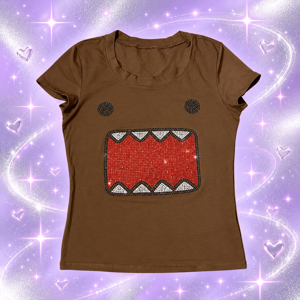 Brown cartoon rhinestone tank top on a sparkly lavender background